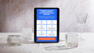 Tablet displaying an e-procurement infographic on a table with glassware.