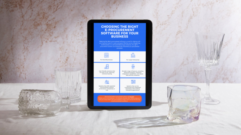 Tablet displaying an e-procurement infographic on a table with glassware.